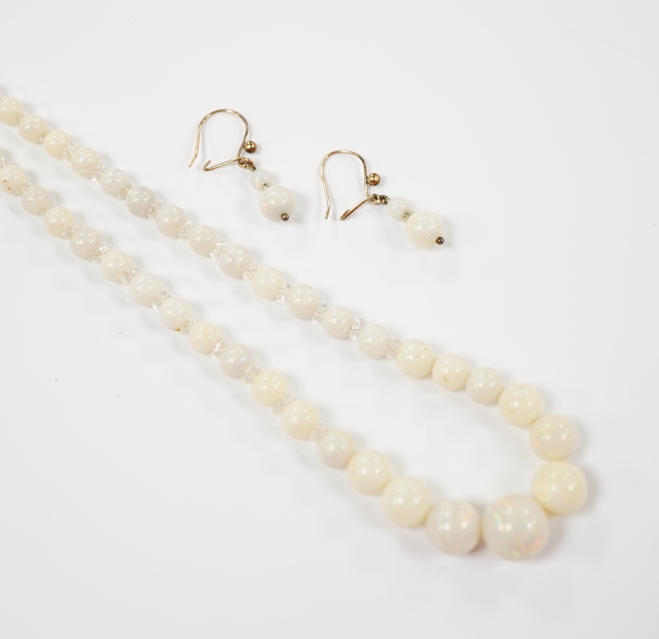 A single strand graduated white opal bead necklace, with 9ct clasp, 50cm and a pair of similar drop earrings.